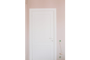 white mdf door with silver handle and a pink surrounding wall